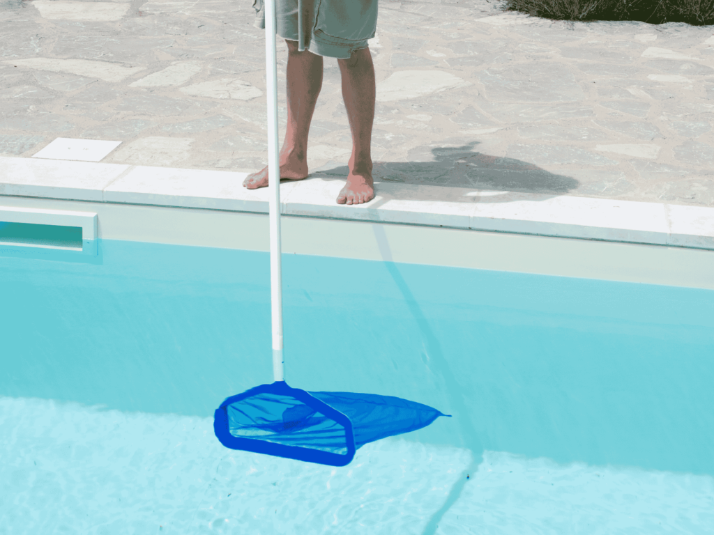 Professional cleaning a swimming pool in Los Angeles, CA, showcasing Encore Pool Care's expertise.